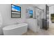 Bright bathroom features a soaking tub and glass shower with marble accents at 5865 Creek Ridge Rd, Brooksville, FL 34601