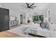 Spacious main bedroom featuring hardwood floors, a king-size bed, and a sitting area with nature views at 5865 Creek Ridge Rd, Brooksville, FL 34601