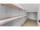 An empty walk-in pantry with new wood shelves offers storage at 5865 Creek Ridge Rd, Brooksville, FL 34601