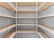 Walk-in pantry with custom wooden shelving, offering ample storage space at 5865 Creek Ridge Rd, Brooksville, FL 34601