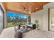 Cozy covered patio with comfortable seating, ceiling fan, and beautiful views of the backyard at 5865 Creek Ridge Rd, Brooksville, FL 34601