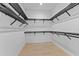 An empty walk-in closet with black metal racks, offering ample storage and organization space at 5865 Creek Ridge Rd, Brooksville, FL 34601