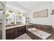 Bathroom showcasing a soaking tub, double sink vanity, and decorative wall accents at 640 Kenneth Way, Tarpon Springs, FL 34689