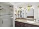Bathroom featuring double sink vanity with granite counters and large glass enclosed shower at 640 Kenneth Way, Tarpon Springs, FL 34689
