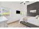 Bright bedroom with wood-look floors, white walls, and large windows at 640 Kenneth Way, Tarpon Springs, FL 34689