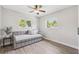 Bedroom with neutral colors, wood floors, and natural light from the two windows at 640 Kenneth Way, Tarpon Springs, FL 34689