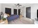 Bedroom with wood floors and bathroom access at 640 Kenneth Way, Tarpon Springs, FL 34689