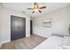 Simple bedroom with wood-look floors and a double door closet at 640 Kenneth Way, Tarpon Springs, FL 34689