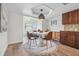 The dining room features wood floors, modern lighting, and access to the living room at 640 Kenneth Way, Tarpon Springs, FL 34689