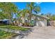 Charming home with lush landscaping, mature trees and a well-manicured lawn at 640 Kenneth Way, Tarpon Springs, FL 34689