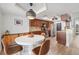 Eat-in kitchen boasts stainless appliances, stone backsplash, and wooden cabinetry at 640 Kenneth Way, Tarpon Springs, FL 34689