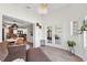 Spacious living room with modern lighting, view into dining and kitchen, and view to exterior patio at 640 Kenneth Way, Tarpon Springs, FL 34689