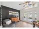 Comfortable living room features a dark accent wall and doors leading to the backyard at 640 Kenneth Way, Tarpon Springs, FL 34689