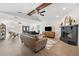 Spacious living room featuring a fireplace, wood beams, and wood-look flooring at 640 Kenneth Way, Tarpon Springs, FL 34689