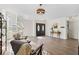 Open-concept living room with spiral stairs, modern decor, a light fixture, and black front doors at 640 Kenneth Way, Tarpon Springs, FL 34689