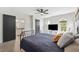 Bright main bedroom with stylish fan, modern black door, ensuite bathroom, and lots of natural light at 640 Kenneth Way, Tarpon Springs, FL 34689