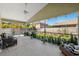 Spacious screened lanai with ceiling fan, outdoor furniture, and views of the expansive backyard at 640 Kenneth Way, Tarpon Springs, FL 34689