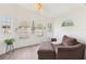 Cozy sitting room with hardwood floors, light walls, and lots of natural light from decorative windows at 640 Kenneth Way, Tarpon Springs, FL 34689