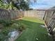 Fenced-in backyard with partial astroturf at 6405 Osprey Lake Cir, Riverview, FL 33578