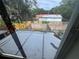 Outdoor view of the backyard showcasing the fence, green grass and barn-style building at 6405 Osprey Lake Cir, Riverview, FL 33578