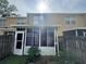 Rear view of a townhouse that includes a screened-in porch and fenced backyard at 6405 Osprey Lake Cir, Riverview, FL 33578
