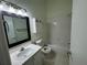 Well-lit bathroom featuring a vanity with modern lighting, and a shower-tub combo at 6405 Osprey Lake Cir, Riverview, FL 33578