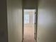 Hallway view leading to a simple bedroom with a window at 6405 Osprey Lake Cir, Riverview, FL 33578