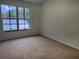 Neutral bedroom with a large window providing natural light and outdoor views at 6405 Osprey Lake Cir, Riverview, FL 33578