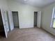 Neutral bedroom featuring two closets with open doors and natural light at 6405 Osprey Lake Cir, Riverview, FL 33578