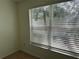 Sunlit bedroom featuring a window providing a view of exterior trees at 6405 Osprey Lake Cir, Riverview, FL 33578