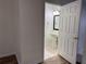 Half bath with a pedestal sink, framed mirror, and neutral decor, viewed from the hallway at 6405 Osprey Lake Cir, Riverview, FL 33578