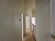 Carpeted hallway featuring neutral walls and white trim at 6405 Osprey Lake Cir, Riverview, FL 33578