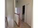 Upstairs hallway with railing leading to bedrooms and bathroom at 6405 Osprey Lake Cir, Riverview, FL 33578