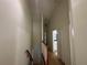 Well lit hallway with wood railing and neutral colored walls at 6405 Osprey Lake Cir, Riverview, FL 33578