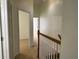 Neutral-toned hallway with carpet leading to bedroom and bathroom entries at 6405 Osprey Lake Cir, Riverview, FL 33578