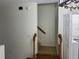 Hallway leading to the stairway with carpet and painted walls at 6405 Osprey Lake Cir, Riverview, FL 33578