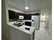 Functional kitchen with white appliances, ample cabinet space, and a view into the living area at 6405 Osprey Lake Cir, Riverview, FL 33578