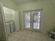 Bright laundry room featuring a washer, dryer, and access to a patio at 6405 Osprey Lake Cir, Riverview, FL 33578