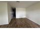 Inviting living room with wood-look tile floors and neutral walls leading to other rooms at 6405 Osprey Lake Cir, Riverview, FL 33578