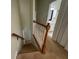 Stairway with carpeted steps, leading to a half bathroom and the upper level at 6405 Osprey Lake Cir, Riverview, FL 33578