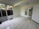 Sunroom with white tile floor, screened windows, and a door to the outside at 6405 Osprey Lake Cir, Riverview, FL 33578