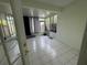 Bright sunroom with white tile flooring and several windows at 6405 Osprey Lake Cir, Riverview, FL 33578