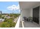 Relaxing balcony with chairs offering a view of lush greenery and neighborhood streets at 700 Beach Ne Dr # 705, St Petersburg, FL 33701