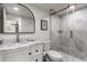 Bright bathroom featuring a marble countertop vanity and a sleek glass-enclosed shower with marble tile at 700 Beach Ne Dr # 705, St Petersburg, FL 33701