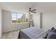 Bright bedroom with a view, wood floors, ceiling fan, and neutral paint at 700 Beach Ne Dr # 705, St Petersburg, FL 33701