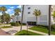 A well-maintained building entrance with lush landscaping, palm trees, and clear signage at 700 Beach Ne Dr # 705, St Petersburg, FL 33701