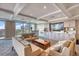 Stylish common room featuring comfortable sofas, built-in cabinetry, and balcony access with beautiful city views at 700 Beach Ne Dr # 705, St Petersburg, FL 33701