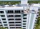 Stunning view of the building's exterior featuring multiple balconies and rooftop terraces with outdoor seating at 700 Beach Ne Dr # 705, St Petersburg, FL 33701