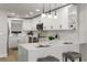 Modern kitchen with sleek white cabinetry, quartz countertops, and stainless steel appliances at 700 Beach Ne Dr # 705, St Petersburg, FL 33701