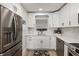 Modern kitchen with stainless steel appliances, quartz countertops, and ample cabinet space at 700 Beach Ne Dr # 705, St Petersburg, FL 33701